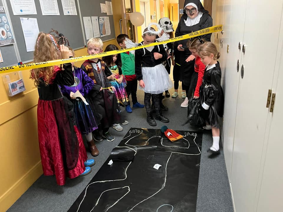This image shows young people at Stagezone's Halloween party investigating a crime scene. Whodunnit?