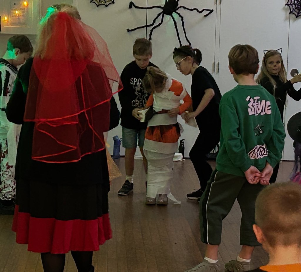 Wrapping a team member in toilet roll to make them a mummy game at Stagezone Youth Theatre