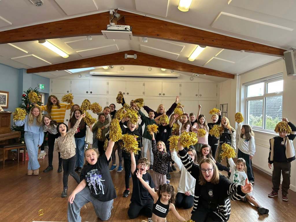 Children rehearsing their Sparkle & Shine song with pom poms at Stagezone Youth Theatre
