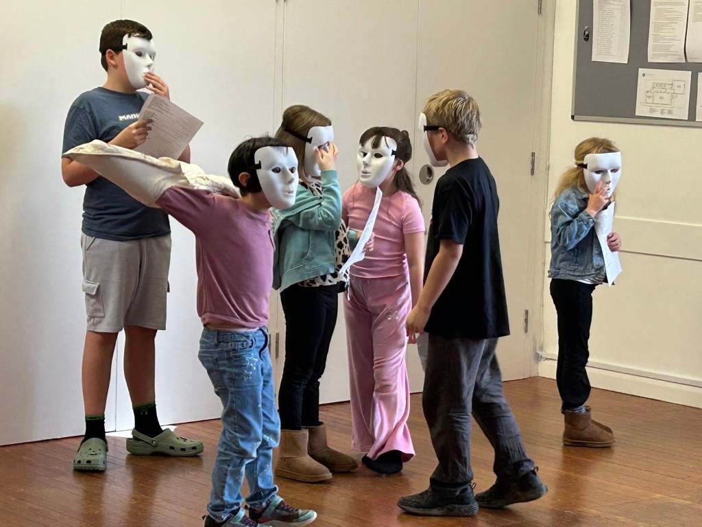 Photo of children having fun wearing masks at Stagezone Youth Theatre's Wicked Workshop